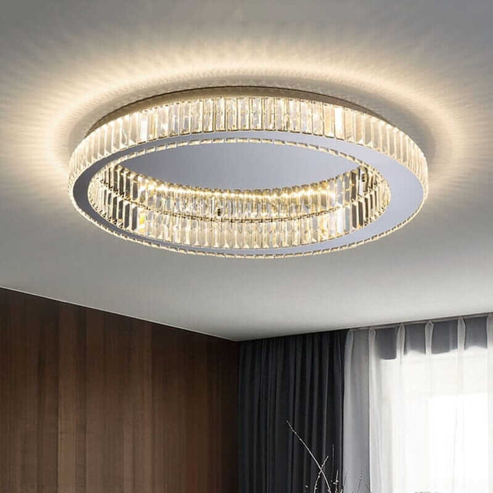 Elegant round chandelier with crystal accents, casting soft ambient lighting in a modern living space.