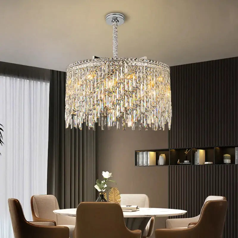 Elegant round chandelier with crystal accents illuminating a modern dining area.