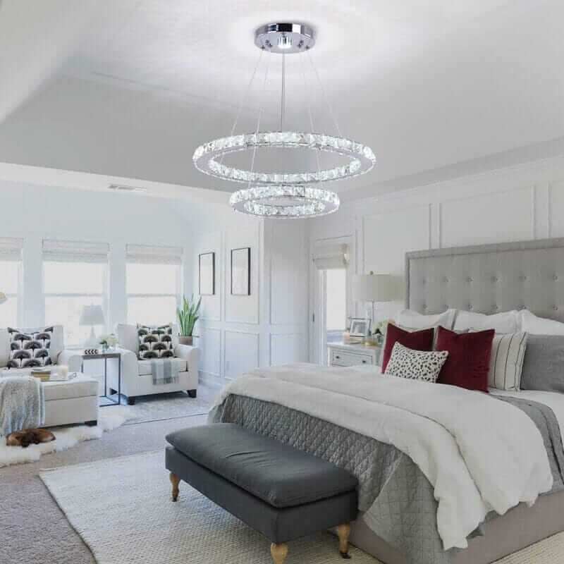 Modern foyer chandelier above a luxurious bedroom with elegant decor and soothing color palette.