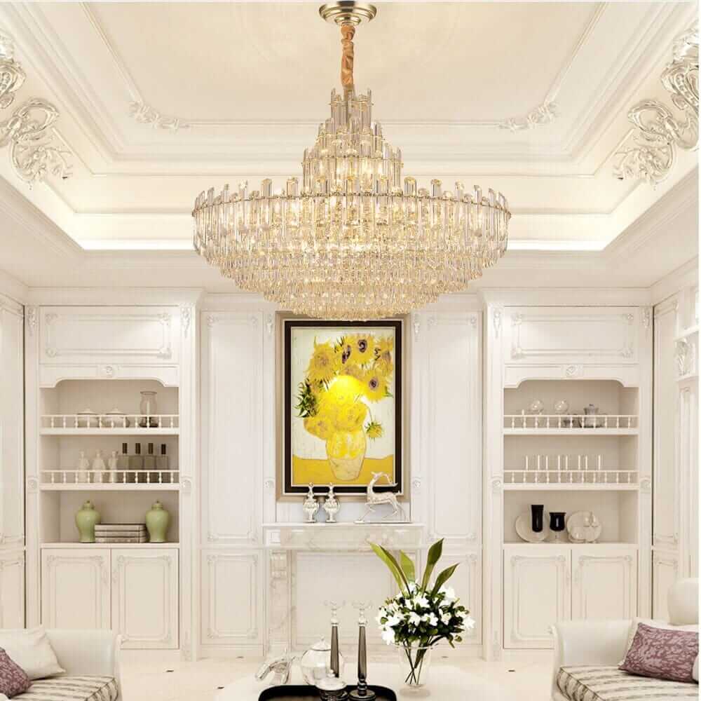 Elegantly designed foyer chandelier in a luxurious white-themed room with crystal accents and artwork.