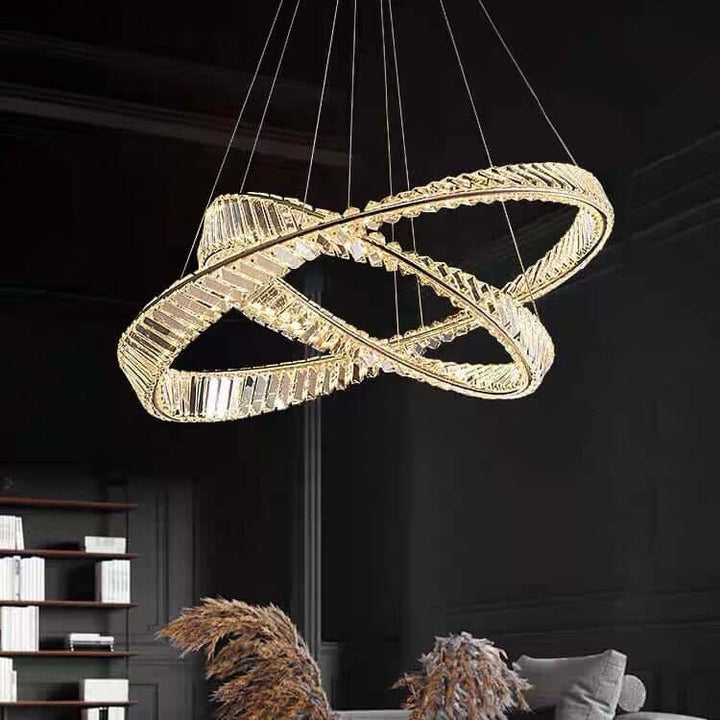 Gold chandelier with crystal design, illuminating a modern living room with elegant decor and warm ambiance.