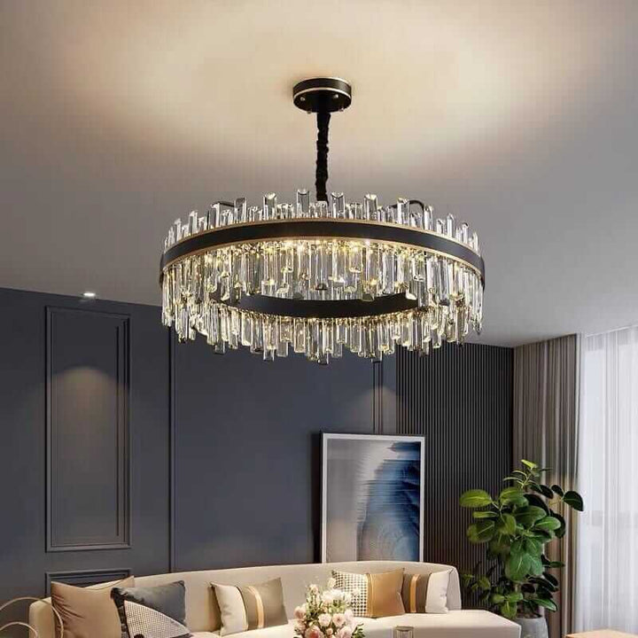 Elegant foyer chandelier with crystal accents, illuminating a modern living room with style and refinement.
