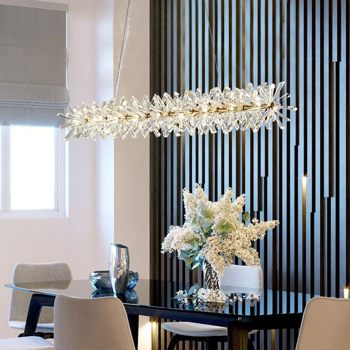 LED chandelier with crystal floral design over a modern dining table, adding glamour to the interior decor.