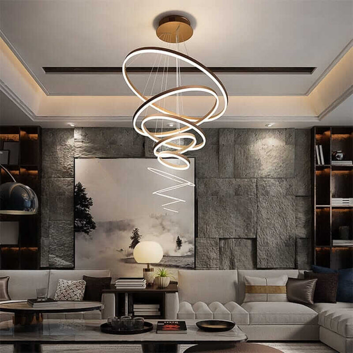 Gold and black chandelier featuring interconnected rings, adding elegance and modern style to a cozy living room.