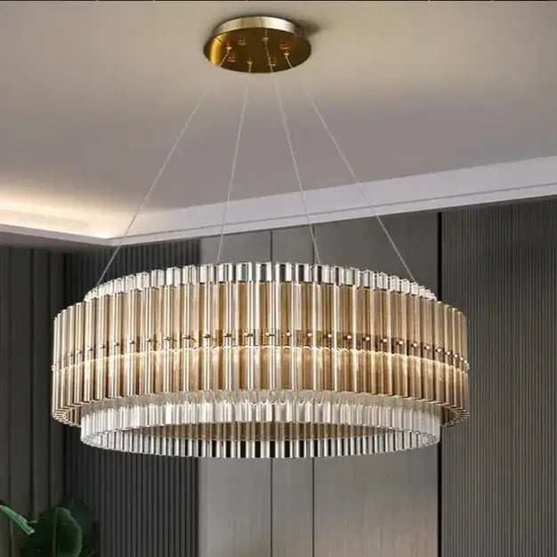 Elegant round gold chandelier with crystal accents, illuminating modern interior space with sophisticated style.