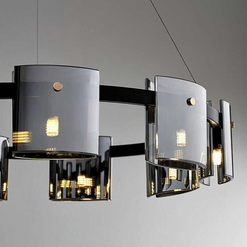 Elegant LED chandelier with sleek black accents and glass panels, illuminating the space with a warm glow.