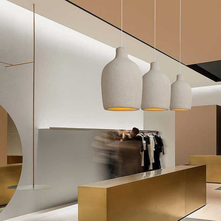 Wabi Sabi Pendant Light trio in a modern store, showcasing minimalist design and elegant illumination.