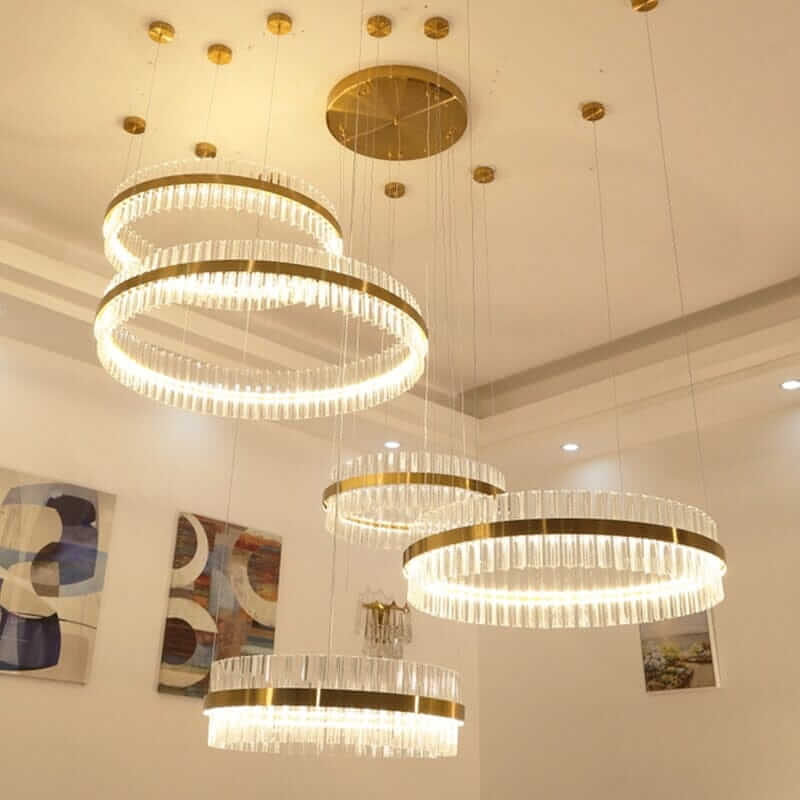 Gold crystal chandelier with circular rings, adding elegance and sophistication to modern interiors.