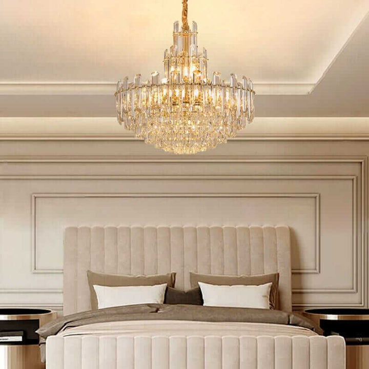Elegant foyer chandelier with gold-plated brass, illuminating a stylish bedroom with modern design.