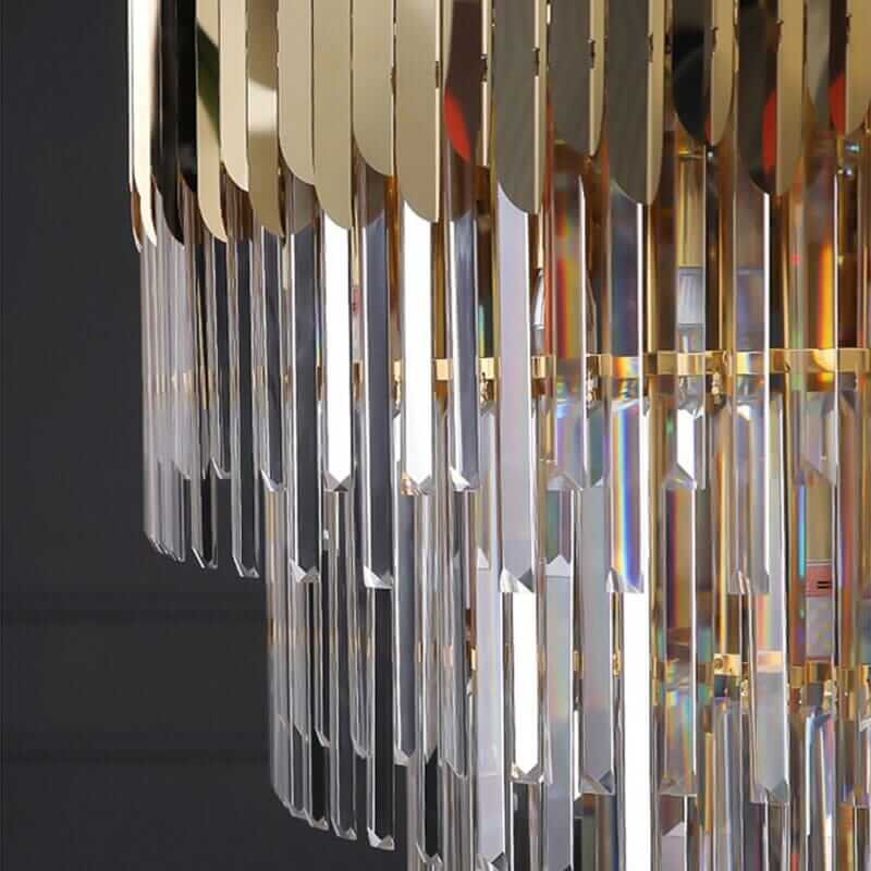 Close-up of a stunning foyer chandelier with polished crystals and a golden frame, showcasing a brilliant light display.