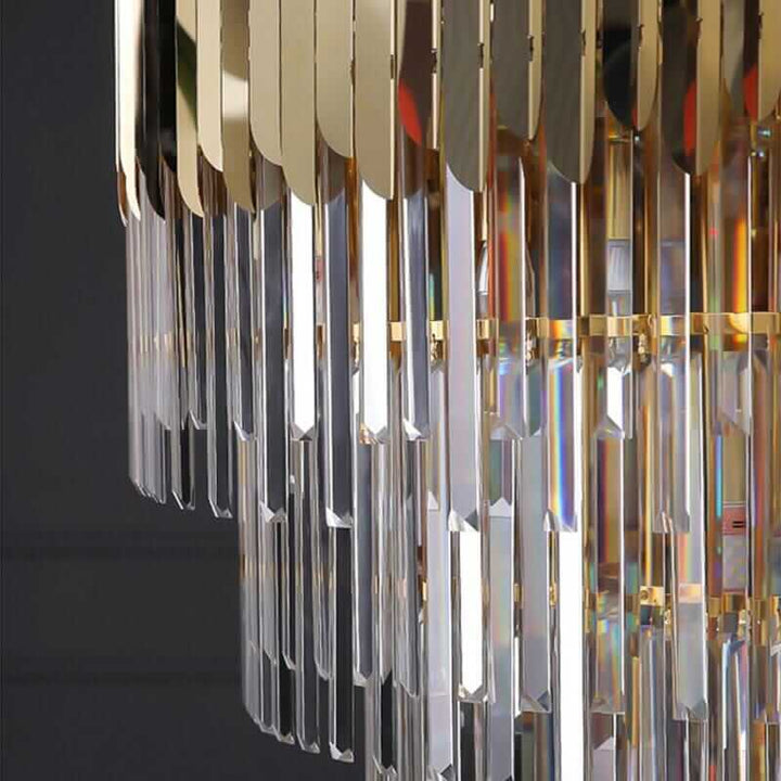 Close-up of a stunning foyer chandelier with polished crystals and a golden frame, showcasing a brilliant light display.