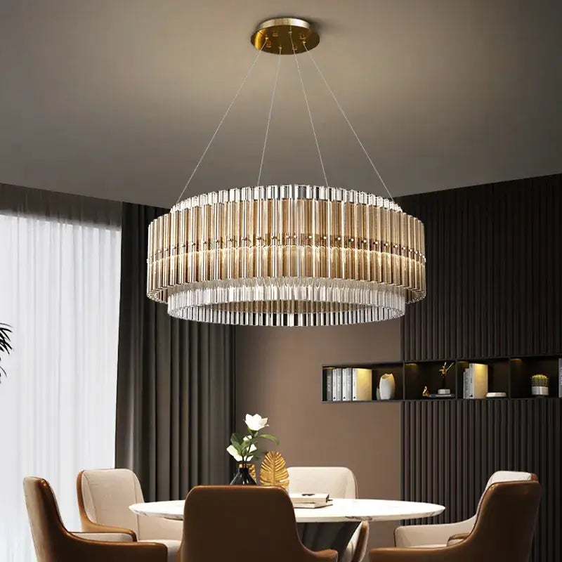 Elegant gold chandelier with crystal accents above a modern dining table, enhancing the room's sophistication and ambiance.