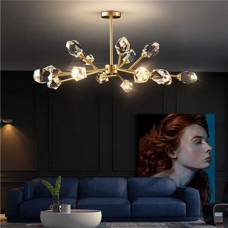 Sputnik chandelier with crystal accents illuminating a stylish living room with a blue sofa and modern artwork.