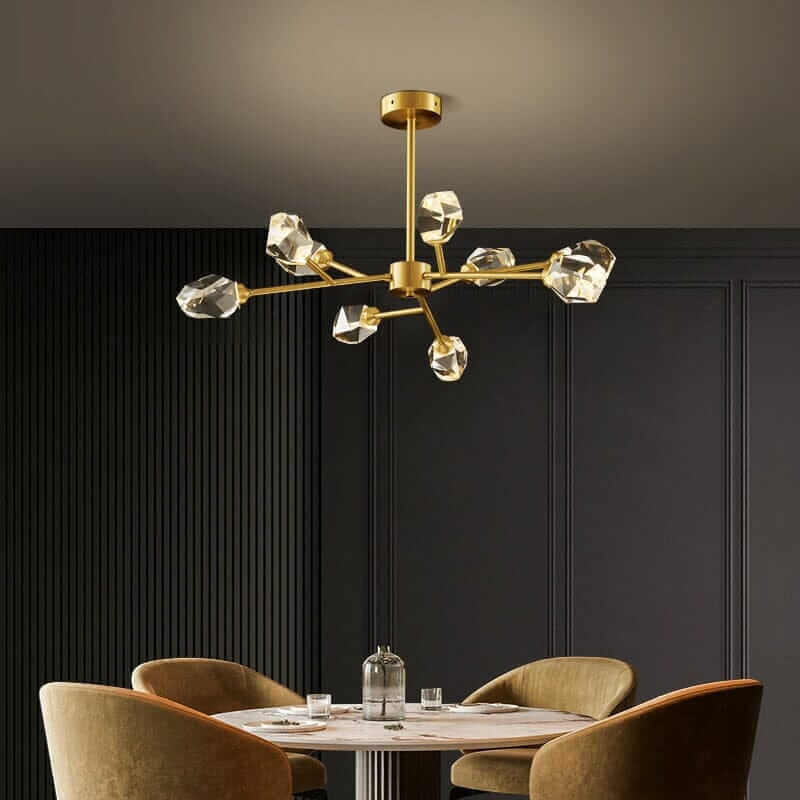 Sputnik Chandelier with golden finish and crystal accents hanging over a modern dining table.