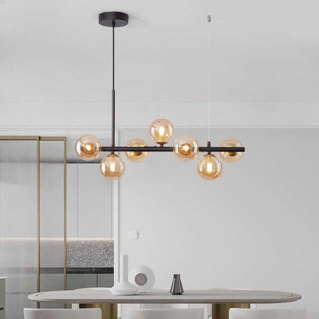 Stylish Bubble Chandelier with multiple glass orbs illuminating a modern dining space.