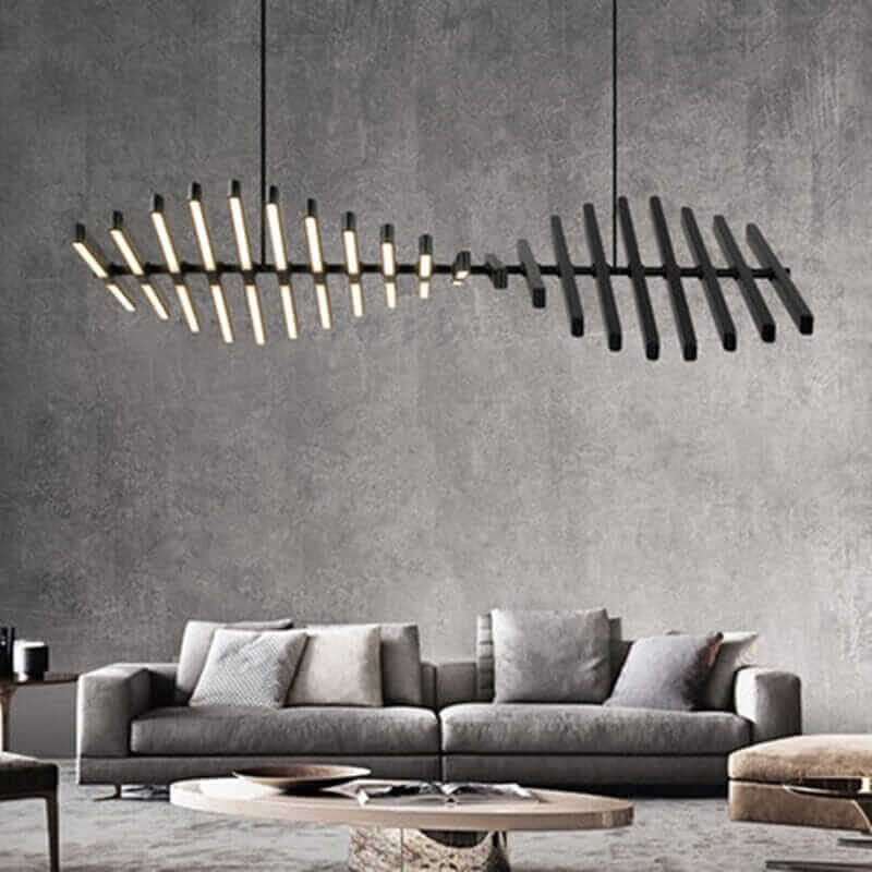 Modern black chandelier resembling a fishbone, illuminating a stylish living room with minimalist design.