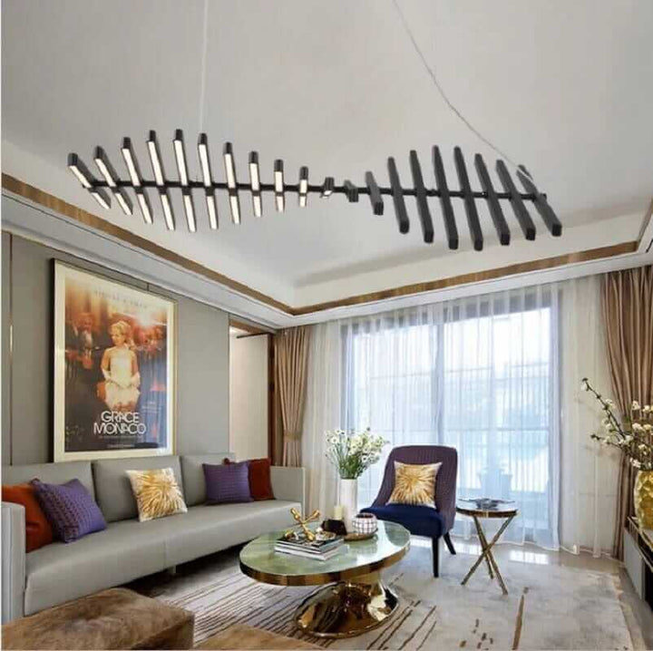Modern black chandelier resembling a fishbone, illuminating a stylish living room with contemporary decor.
