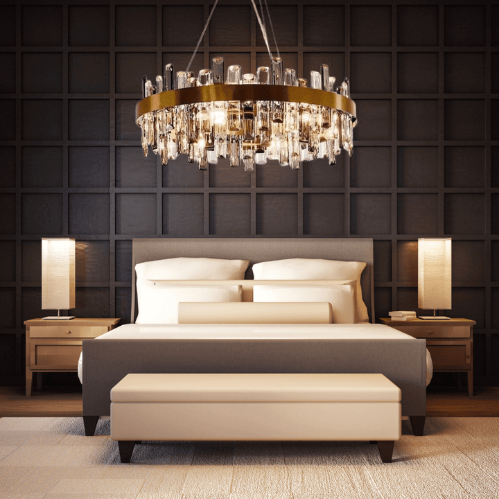Gold crystal chandelier above a stylish bed in a modern bedroom, adding elegance and luxury to the decor.