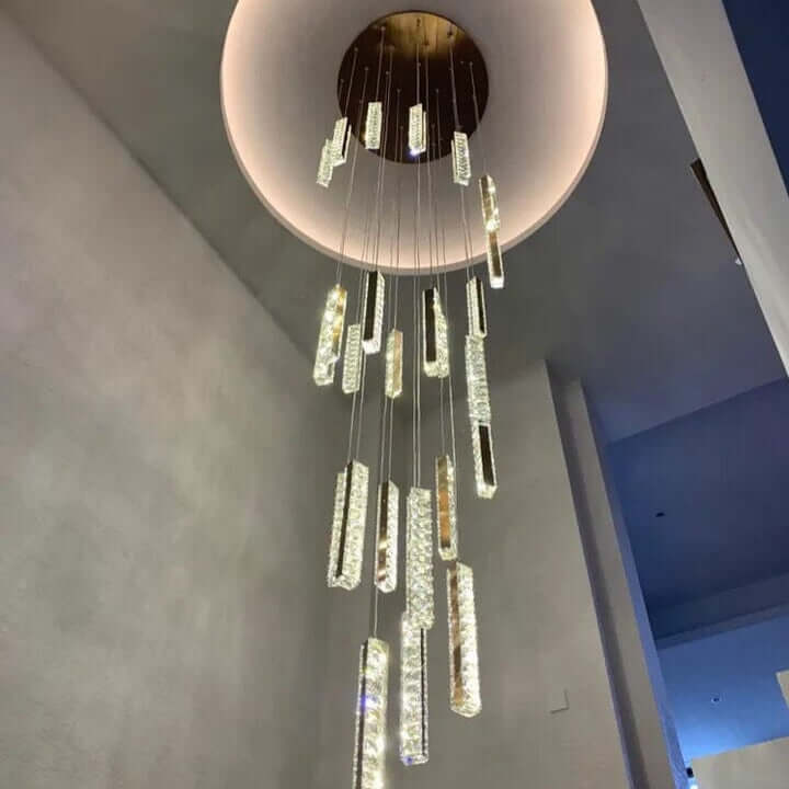 Stunning modern staircase chandelier with cascading crystal light elements, enhancing elegance and ambiance.