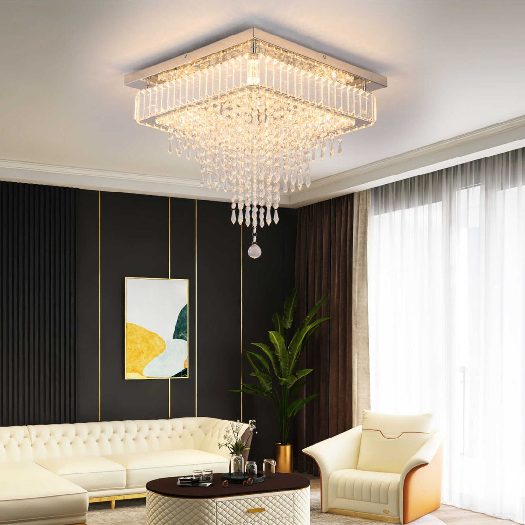 Freddie Square Crystal Ceiling Chandelier illuminating a modern living room with elegant decor and lush green plants.