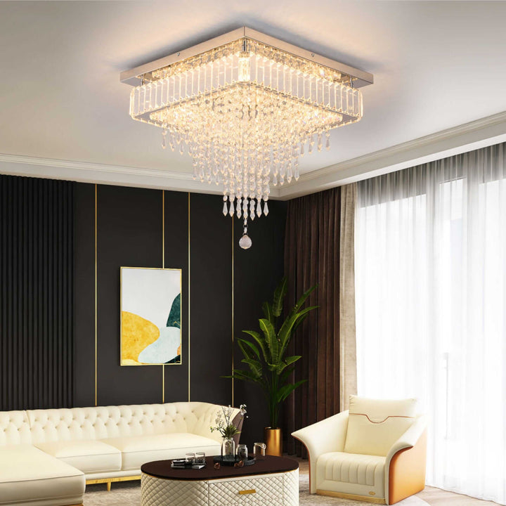 Freddie Square Crystal Ceiling Chandelier illuminating a modern living room with elegant decor and lush green plants.