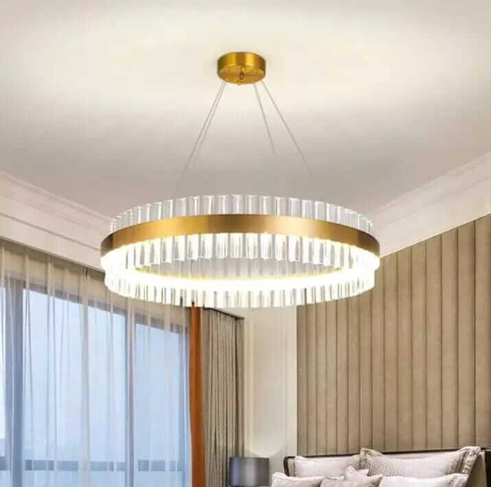 Gold crystal chandelier illuminating a modern living space with elegance and sophistication.