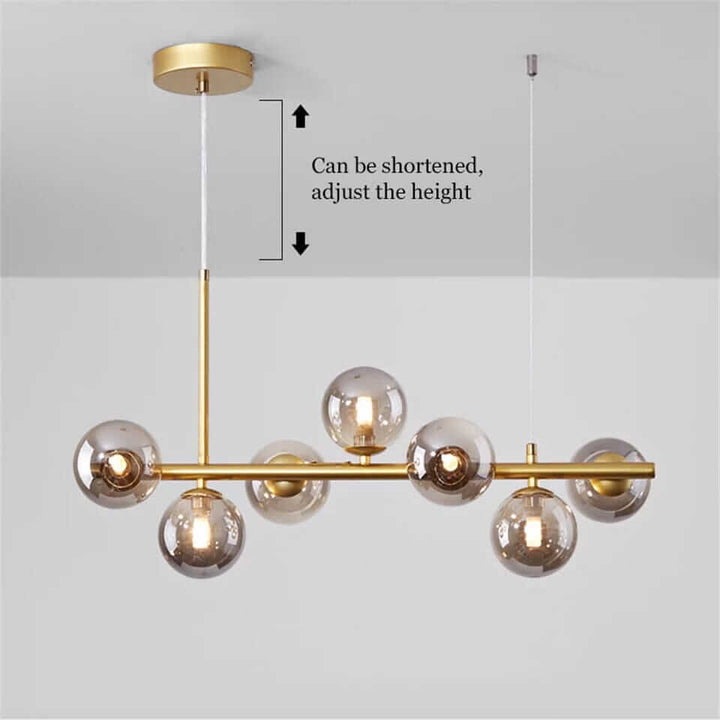 Modern bubble chandelier with adjustable height, featuring gold finish and transparent globes, perfect for contemporary spaces.