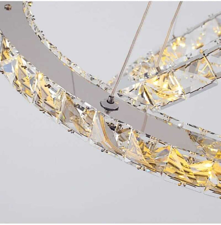 Close-up of an elegant entryway chandelier showcasing glass crystals and warm lighting, perfect for stylish home décor.