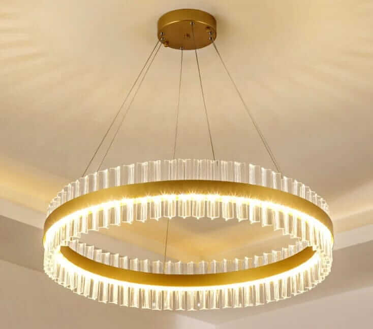 Gold crystal chandelier with elegant design, illuminating a modern space with sophisticated light.