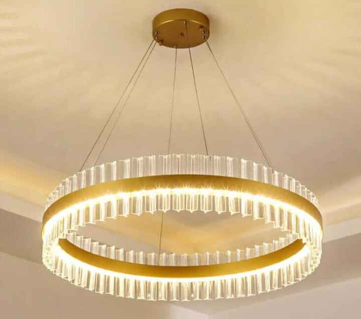 Gold crystal chandelier with elegant design, illuminating a modern space with sophisticated light.