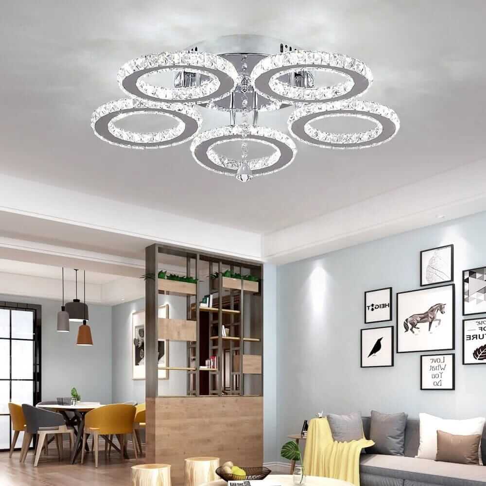 Small crystal chandelier with circular tiers, adds elegance and glamour to modern home decor.