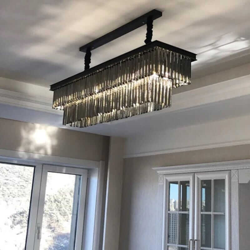 Stylish black chandelier with crystal accents illuminating a modern interior.
