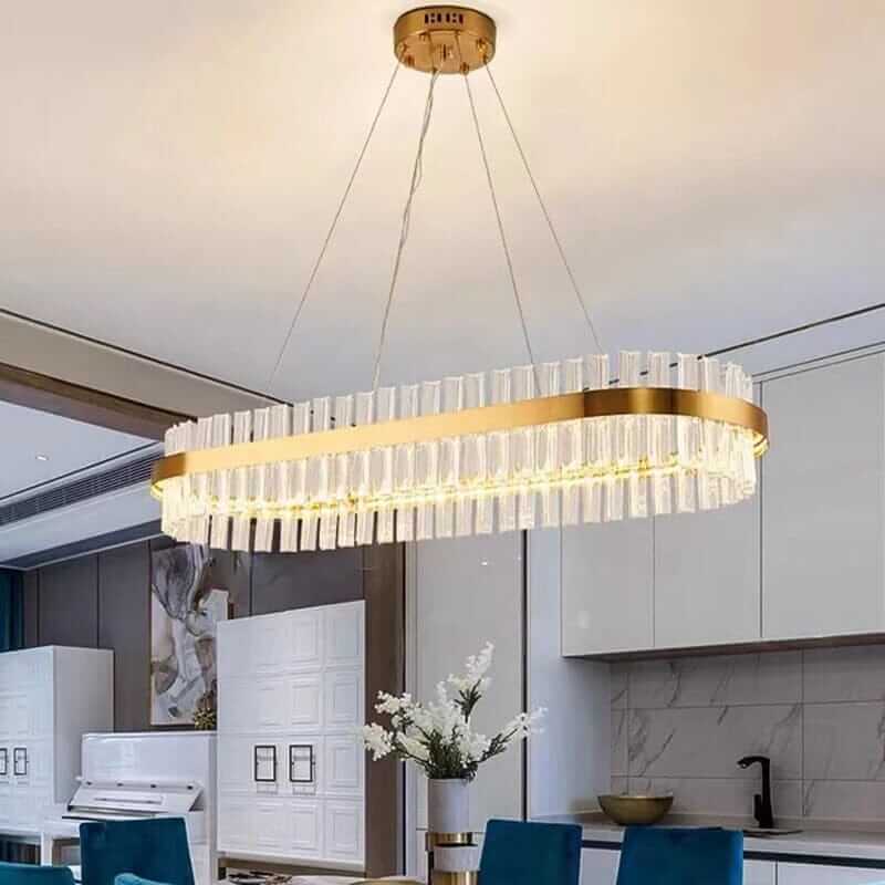 Stylish gold crystal chandelier hanging in a modern kitchen, adding elegance and sophistication to the space.