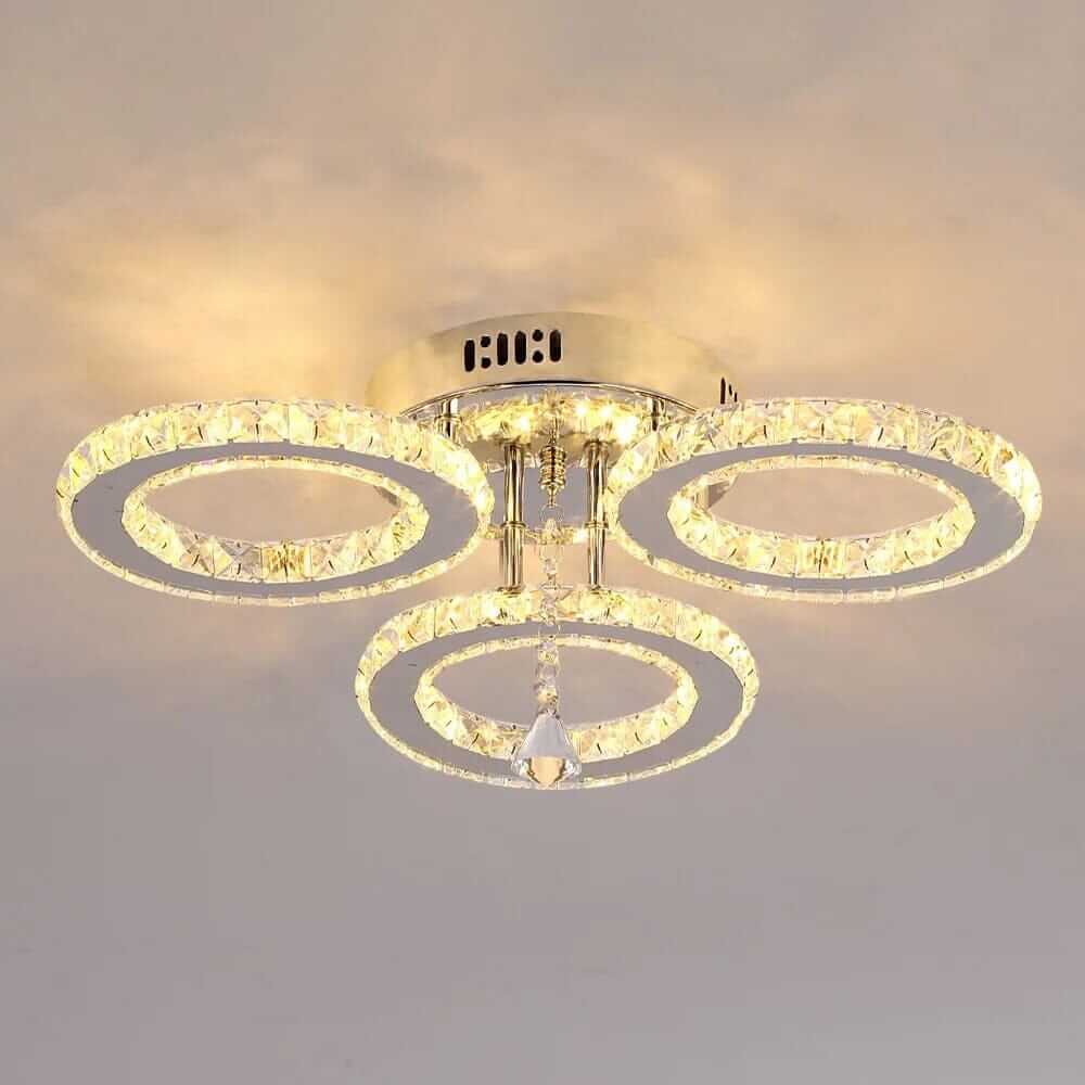 Small crystal chandelier with three tiered rings, adding elegance and glamour to any home decor.