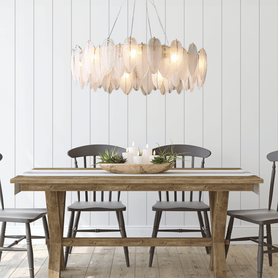 Stylish entryway chandelier featuring leaf-shaped design, illuminating a rustic dining table with wooden chairs.