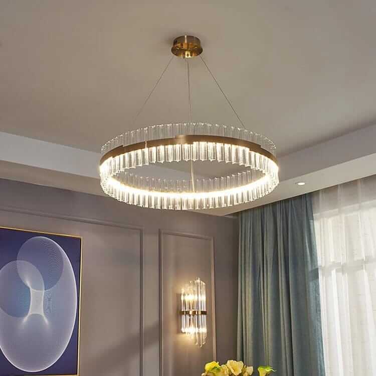 Gold crystal chandelier illuminating a modern room, adding elegance and sophistication to the interior decor.