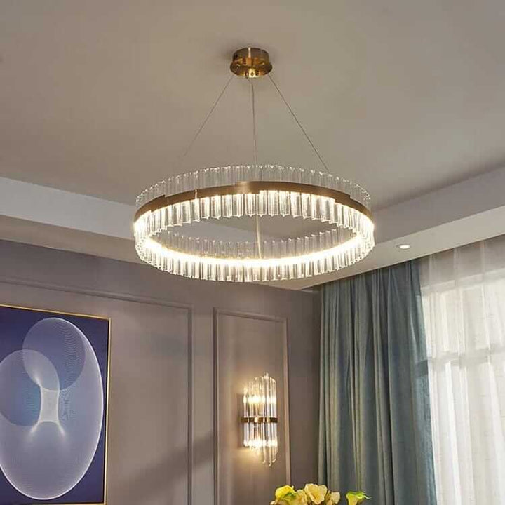 Gold crystal chandelier illuminating a modern room, adding elegance and sophistication to the interior decor.