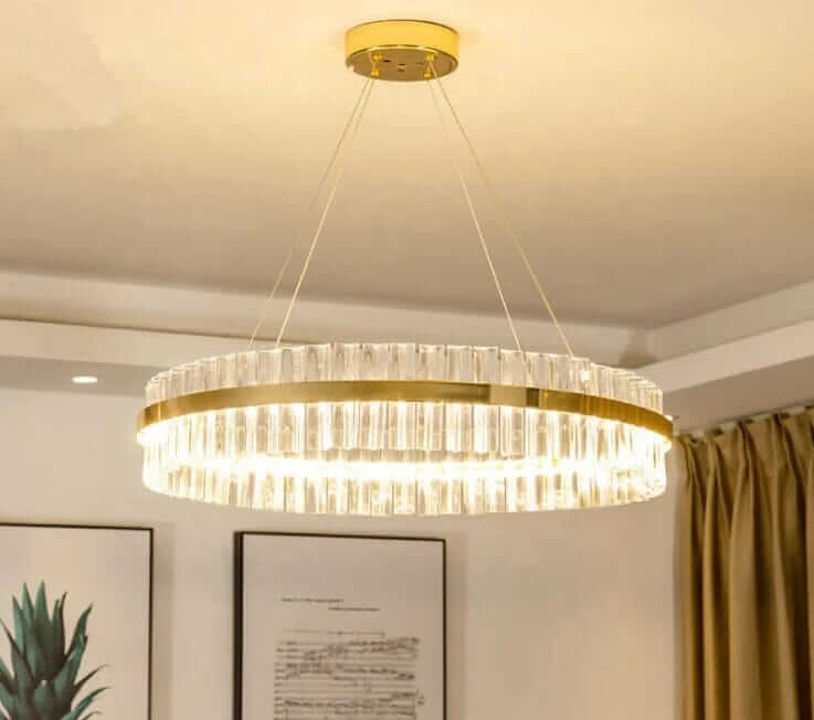 Gold crystal chandelier illuminating a modern room, adding sophistication and elegance to the decor.