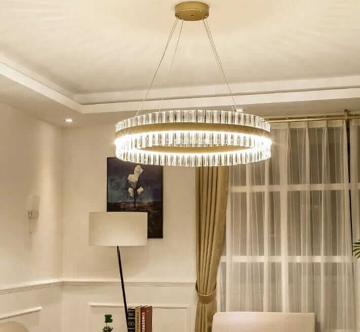 Gold crystal chandelier illuminating a stylish room, adding elegance and sophistication to the decor.