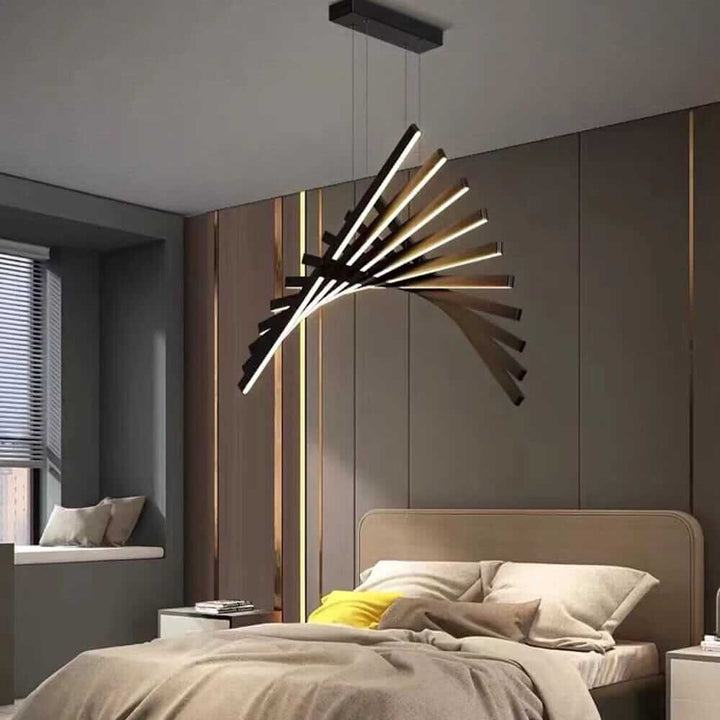 Modern black chandelier designed to resemble a fishbone, illuminating a stylish bedroom with clean lines.