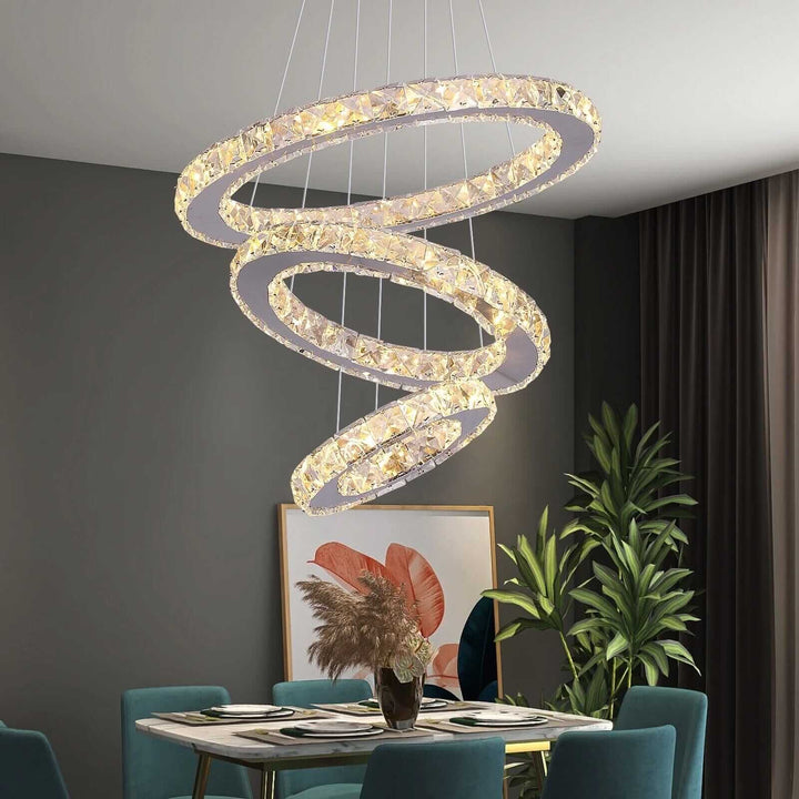Sleek entryway chandelier with three spiraling rings, adding elegance and warmth to home décor.