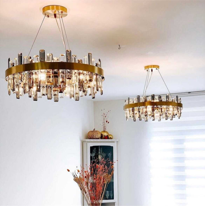 Gold crystal chandelier illuminating a modern interior, adding elegance and luxury to the decor.