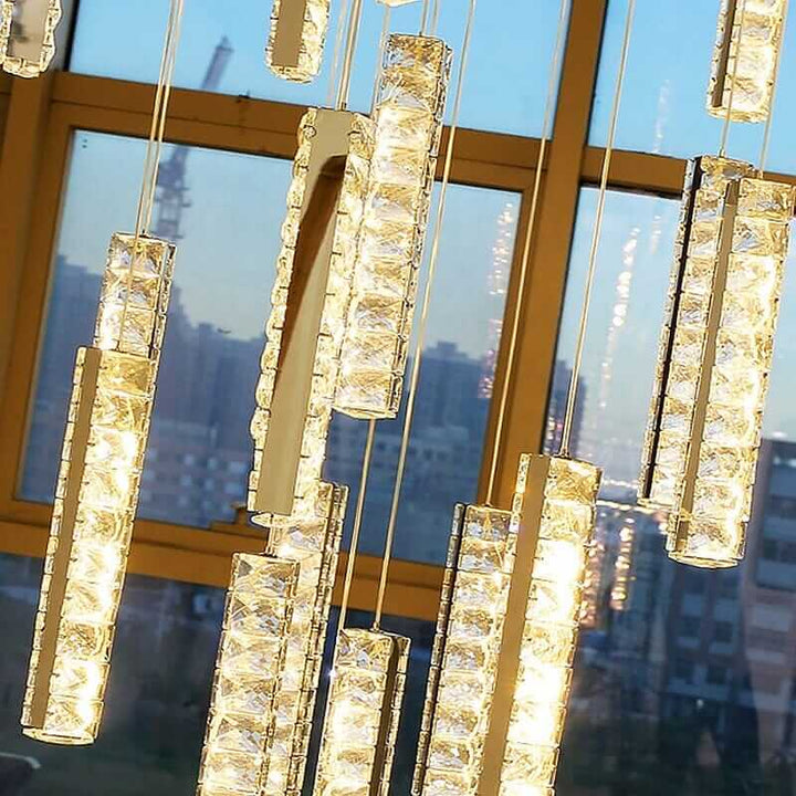 Elegant LED chandelier with crystal elements, casting a warm glow for modern staircase decor.