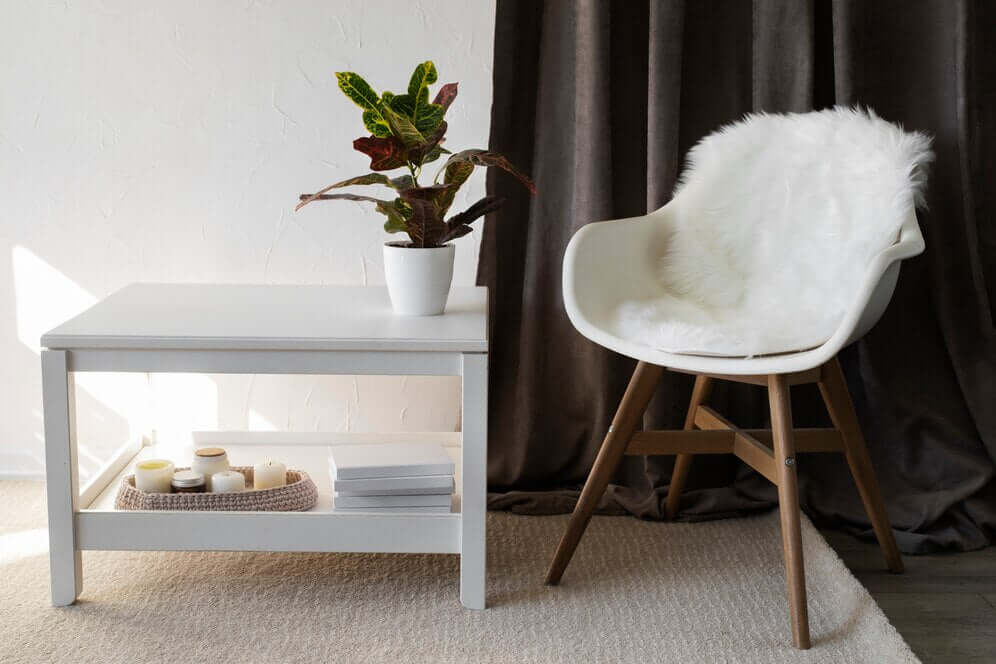 Stylish side table with a plant and chair, enhancing home decor and functionality with side tables.