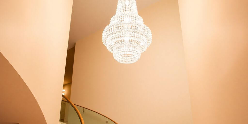 Grand staircase with a dramatic crystal chandelier.