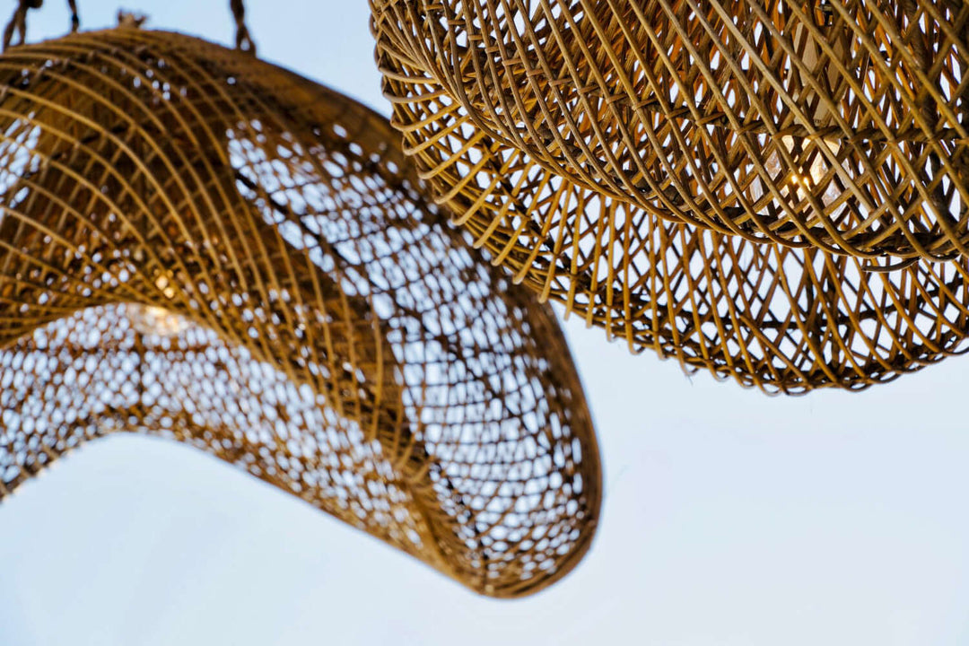 Rattan Lighting featuring beautifully woven rattan light fixtures hanging against a clear sky.