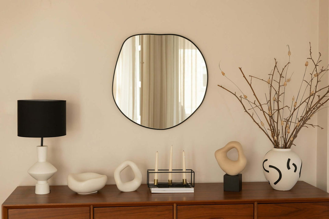 Decorative mirrors enhancing a bright home atmosphere with modern decor and a stylish lamp.
