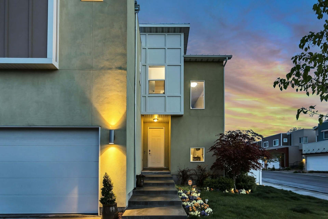 Stunning outdoor lighting illuminating a modern home's entrance at dusk, enhancing safety and style with effective outdoor lighting.