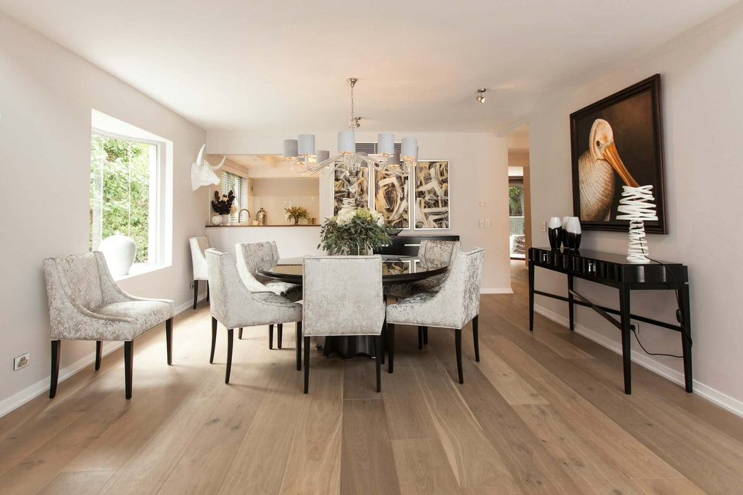 Stylish dining chairs around a round table in an elegant dining room with modern decor and natural light.