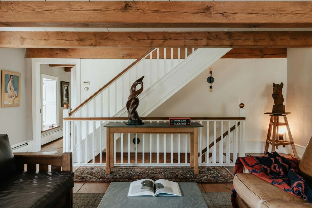 Artistic Sculptures enhancing a cozy home interior with wooden beams and a stylish staircase.